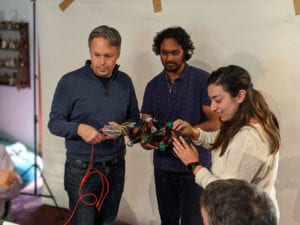 Three people using robot controller